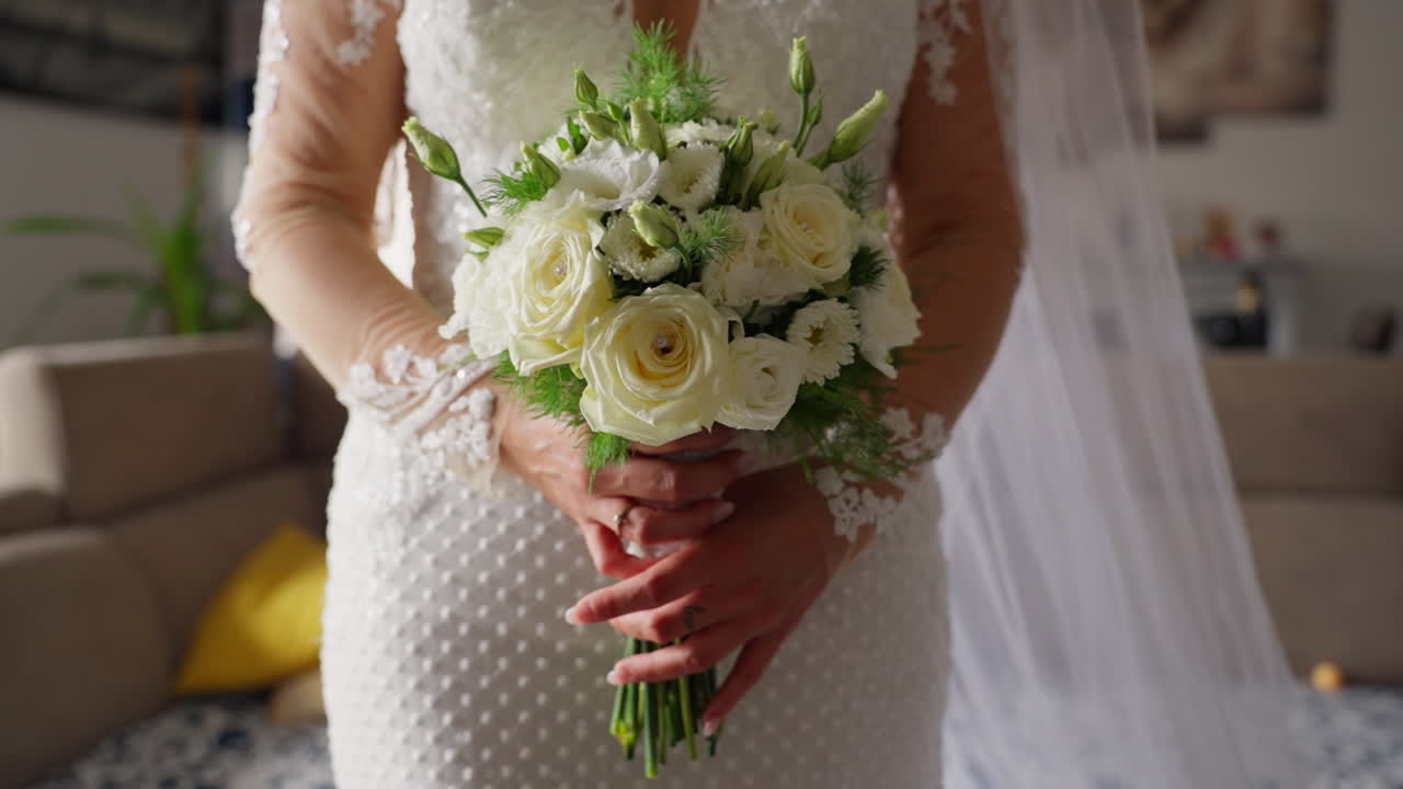 Bride holds bouquet in elegant dress, feeling love and anticipation
