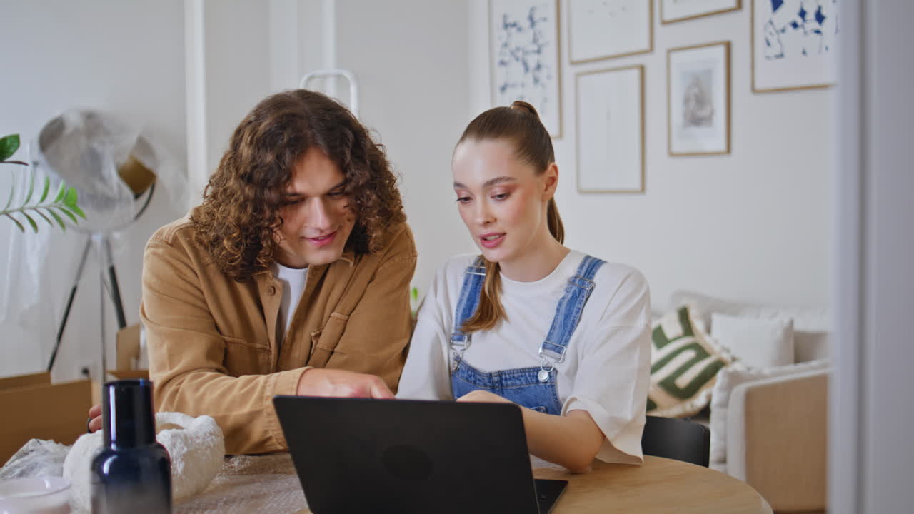 Family choosing online purchases at laptop sitting together at apartment closeup