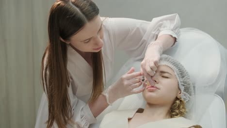 close-up of cosmetologist performing facial injection