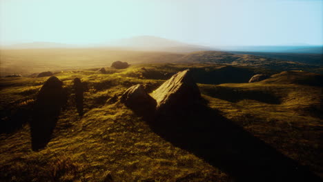 stunning sunset over a grassy field with rocks