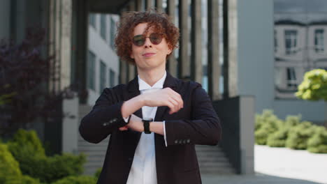 smart looking young businessman in suit smile to camera showing confident ready for big day at work
