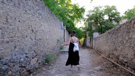 a woman walks among historical buildings historical street