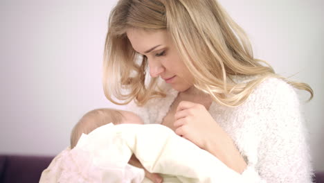 Feminine-woman-enjoy-breastfeeding-child.-Mother-breast-feeding-kid