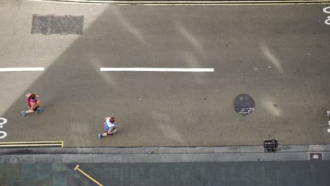 slow motion aerial view of joggers on street