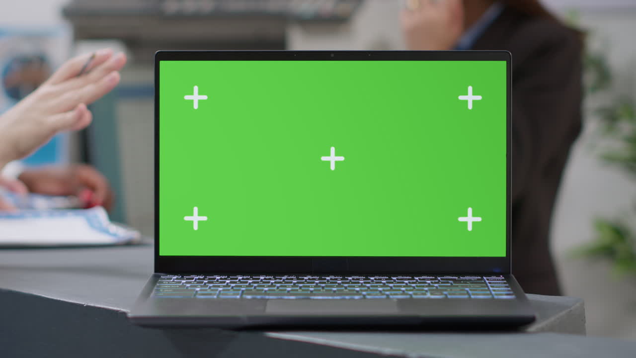 Laptop with Green Screen in Office Setting
