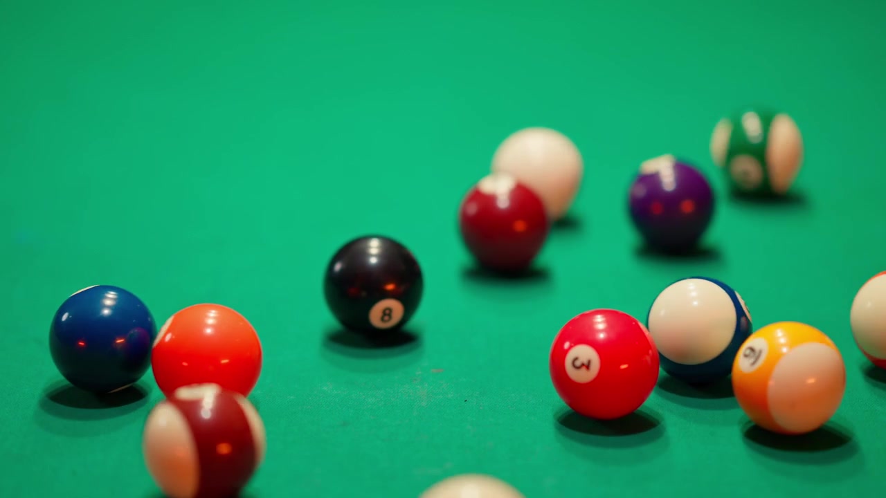 Cue Ball Breaks Rack of Colorful Pool Balls on Green Table