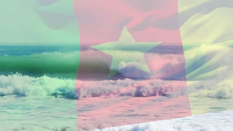 digital composition of waving cameroon flag against waves in the sea