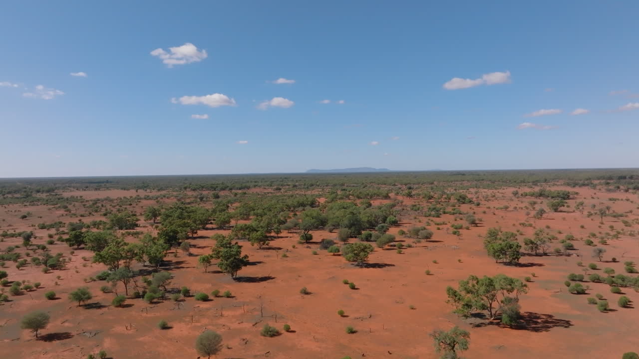 Aerial: Drone shot of Mount Gunderbooka on the horizon in the Australian outback near Bourke,