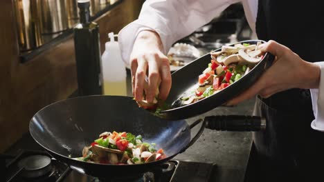 chef adding vegetables on the pan