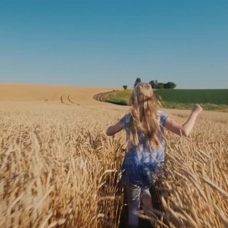 blonde girl runs in a wheat field