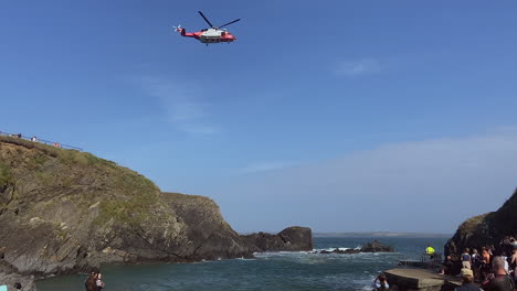 irish coastguard helicopter prop kicks up sea water during rescue