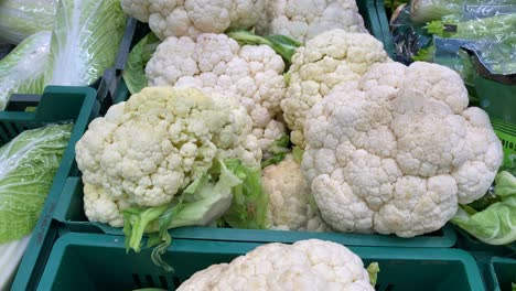 white cauliflower lies on the counter in plastic pallets