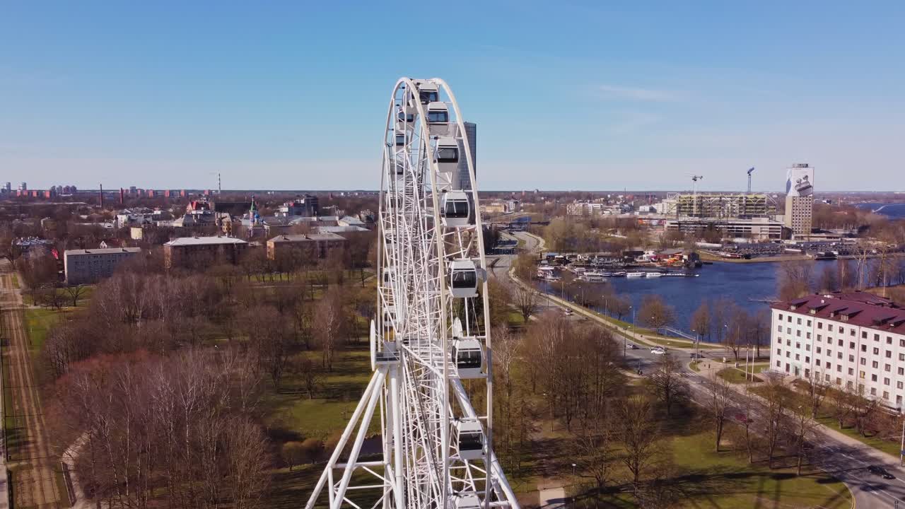 Beautiful Ferris wheel with panoramic views of Riga skyline, aerial view