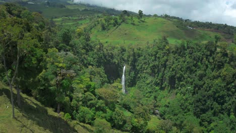 hidden muralla waterfall in costa rica, lush green landscape with cascade, aerial