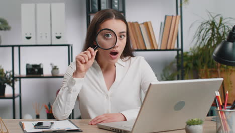 Business-woman-holding-magnifying-glass-near-face,-looking-with-big-zoomed-eye,-searching,-analysing