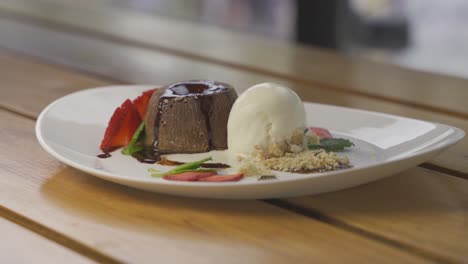 4k close up shot of tasty vanilla chocolate dessert served on fancy plate in restaurant