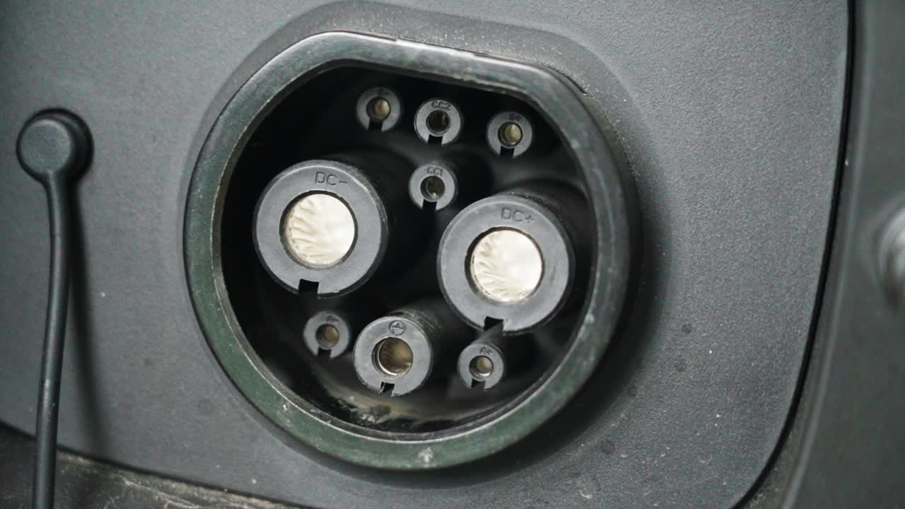 Close-up detail of a DC charging port and connector on an electric vehicle. High-power charging interface supporting fast charging infrastructure, electric mobility, and sustainable transportation