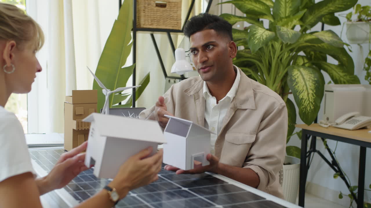 Female Client Listening to Green Energy Solutions Company Consultant