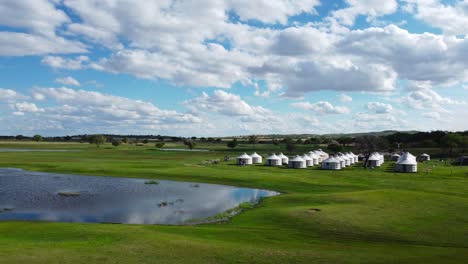 Mongolian-grassland-yurt-campsite-close-to-a-pond-in-Central-Asia