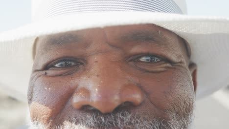 Portrait-of-senior-african-american-man-on-promenade-by-the-sea,-slow-motion