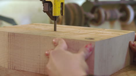 bespoke shoemaker cutting wooden last for shoe using jigsaw