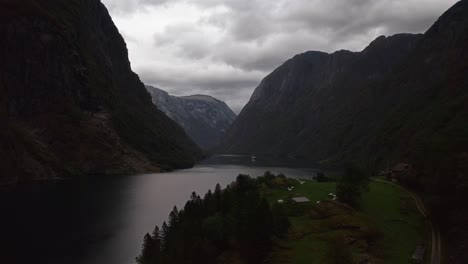 misty fjord in norway with a serene, still landscape and towering mountains