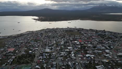 puerto natales cityscape, chilean patagonian city, aerial drone above town, gulf montt water and dreamy peaceful landscape