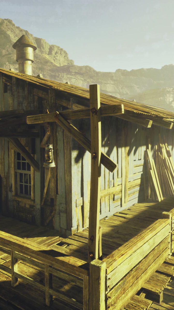 Rustic wooden cabin nestled in rocky terrain during sunrise glow