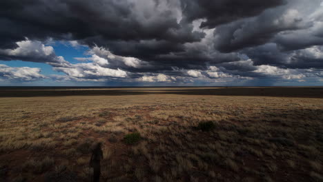 dramatic sky over a dry plains landscape with person