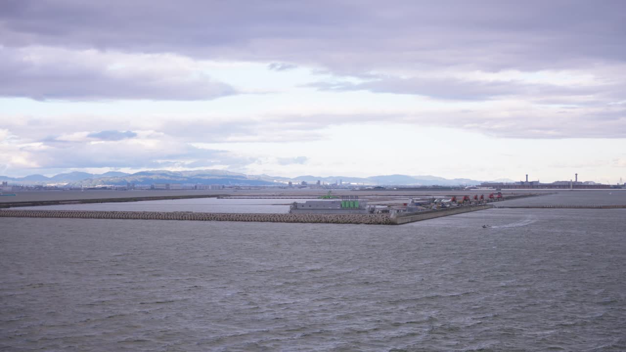 구름이 가득한 하늘 아래의 해안 산업 항구