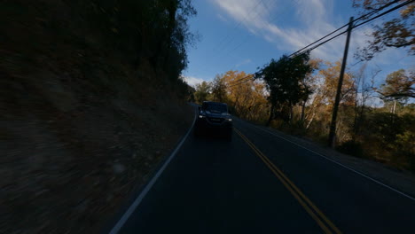 backward fpv shot of a police car traveling through the countryside