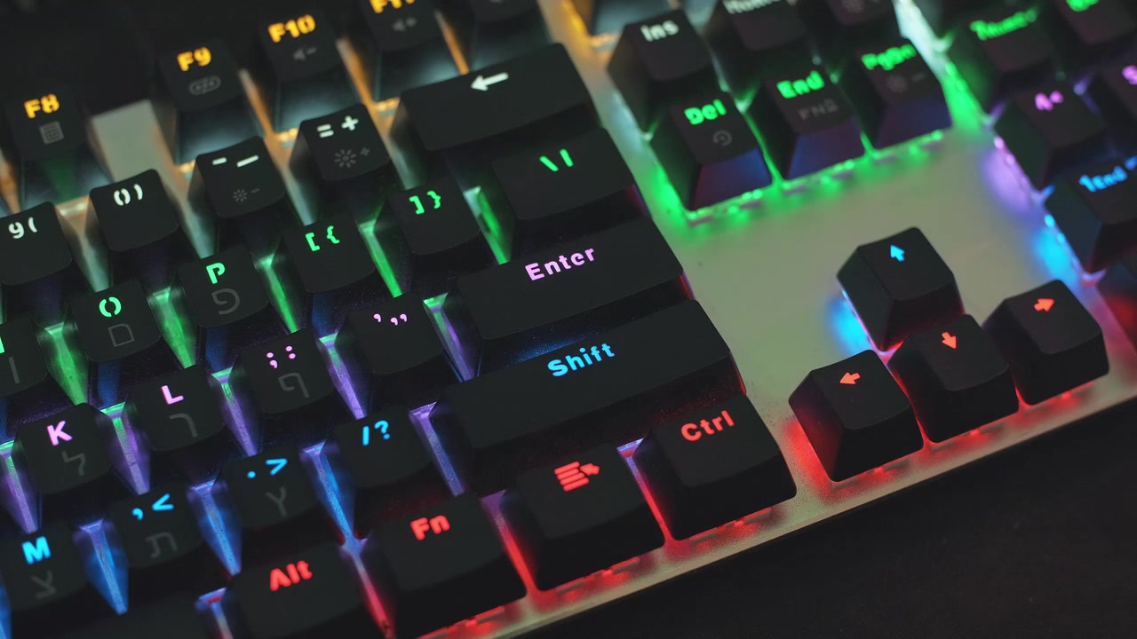 video editor freelancer hands, , editing videos at his desk in a foggy room, click enter on his RGB keyboard. tripod close up shot.