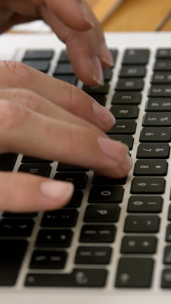 Close up view of masculine hands typing on a laptop