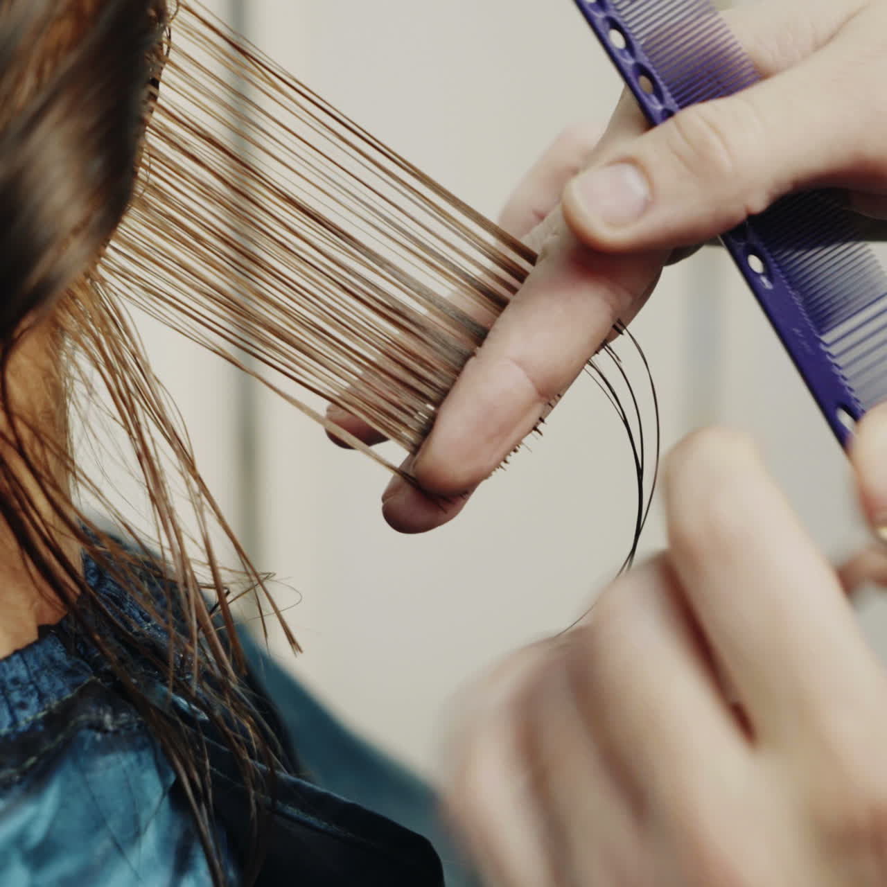 Women's haircut. Beautiful woman getting haircut by hairdresser in the beauty salon. Square video