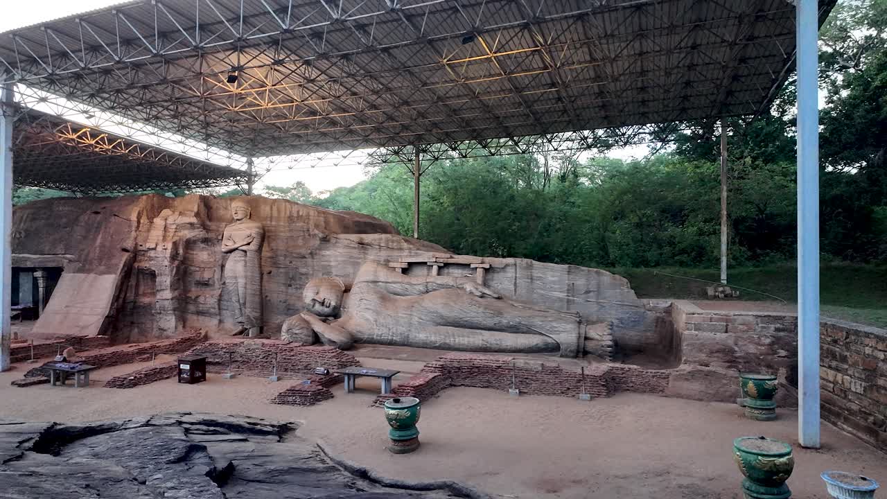 Majestic rock carvings of Buddha at Uththararamaya (Gal Vihara), located in the ancient city of Polonnaruwa, showcasing spiritual art in a serene natural setting.