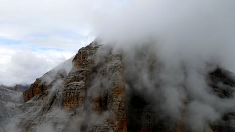 aerial views of italian dolomites peaks in a foggy and cloudy day