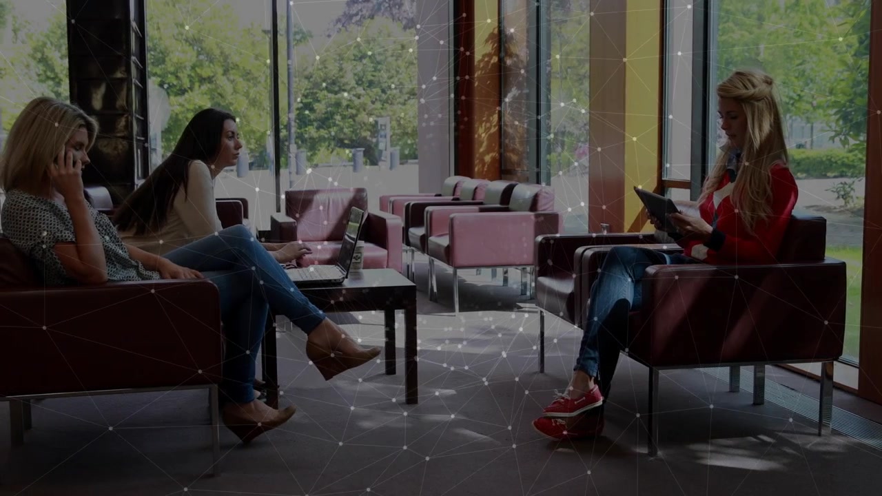 Woman in red tapping tablet in lobby generating animated marketing chart on tablet to analyze data