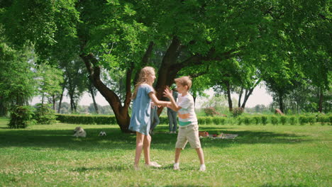 children have fun playing active games on nature. happy family leisure concept.