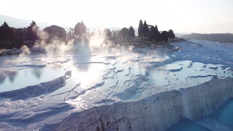 Steamy-blue-hot-springs,-mineral-waters,-forming-travertine-limestone-mineral-deposit-formations