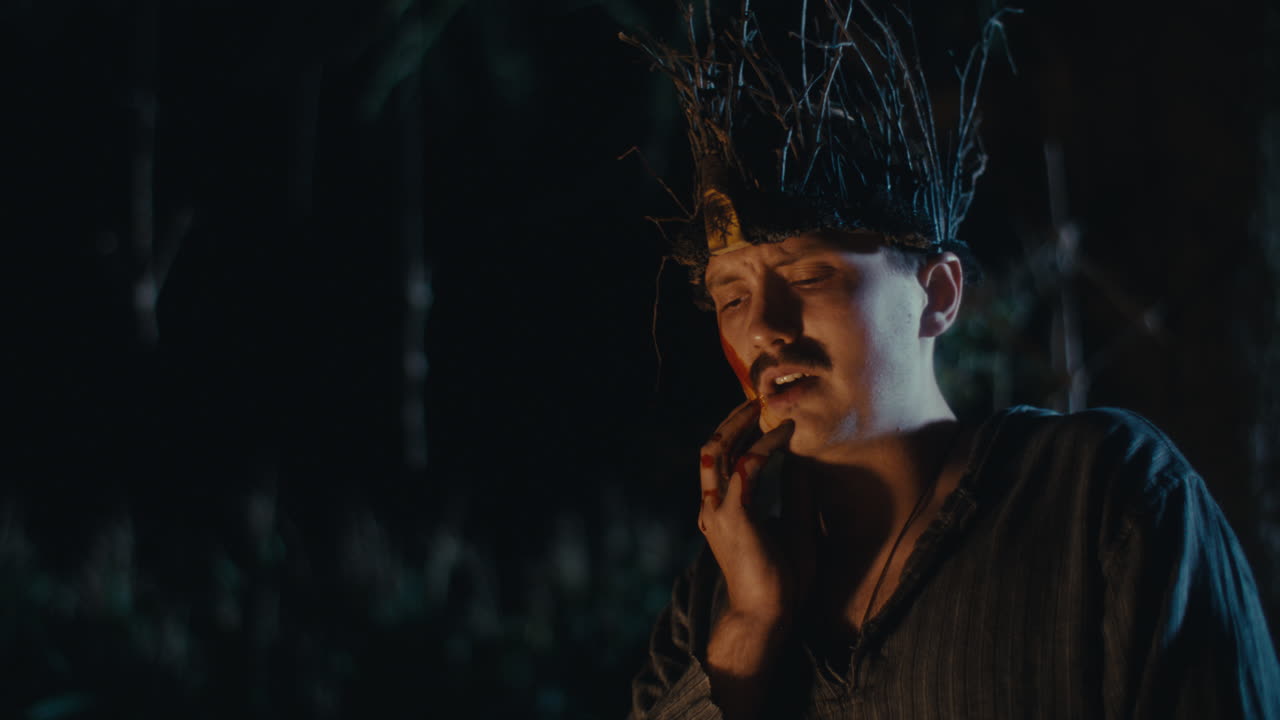 Distressed Man in Branch Crown with Blood in Dark Forest