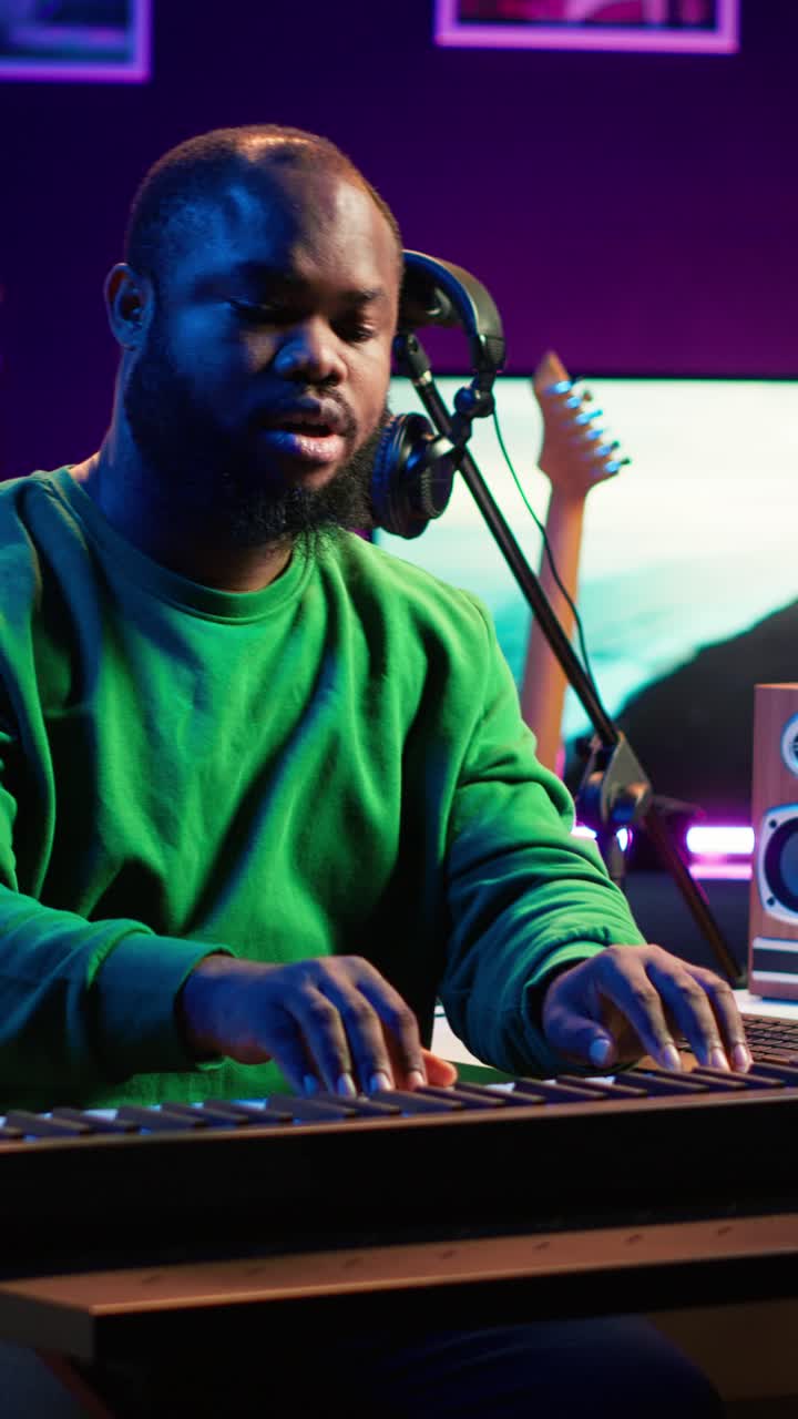 African American Man Playing Keyboard and Producing Music in Studio