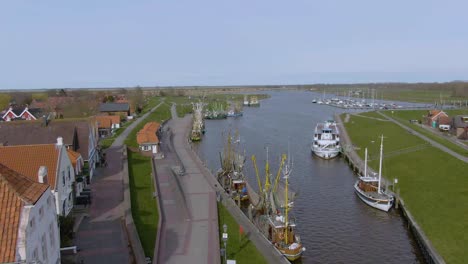 Drone-flight-over-a-tranquil-small-fishing-harbor-in-germany