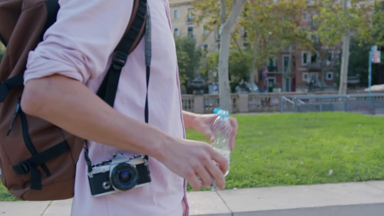 A person outdoors with a camera and backpack