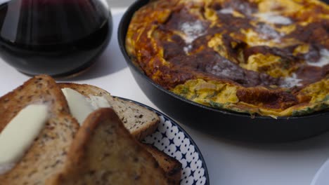 close up panoramic view of perfect breakfast with beacon, omlet and toasted garlic bread