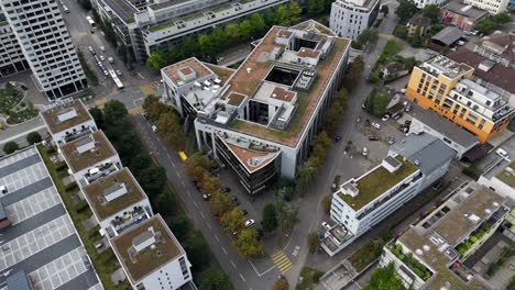 aerial tilt down of luxury residential complex with green rooftop garden in downtown of zurich, switzerland