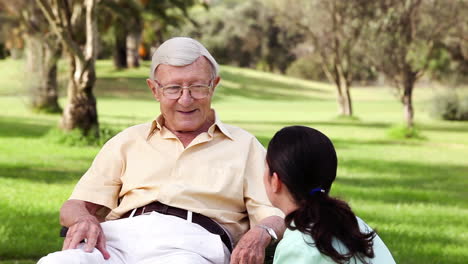 old man talking with a nurse crouched