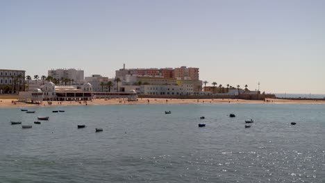 wide open view over beautiful ocean at cadiz beach with fishing boats and beach