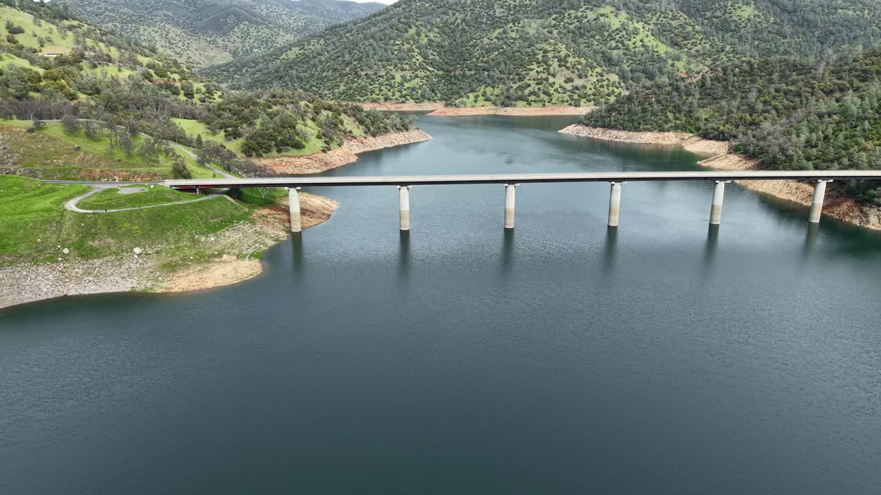 Golden California hills frame the Don Pedro Reservoir Bridge in this aerial drone shot. Shot on an Air 3S.