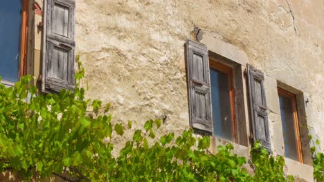 closeup footage of wooden windows and historic architecture of buildings at a typical french village