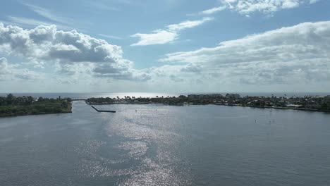 early morning time-lapse looking ease toward ocean inlet park in boynton beach florida showing flowing clouds wispy water and sheen on the intercoastal